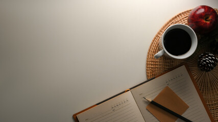 Comfortable and cozy workspace with diary book, coffee mug and copy space.