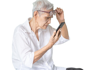Asian senior woman with eye glasses,try to read messages,gaze at the small text on mobile phone,age...