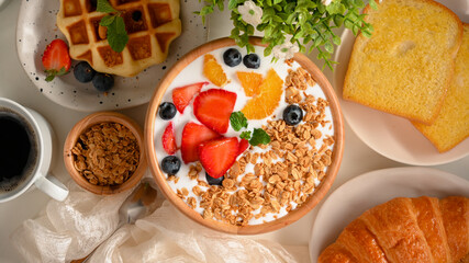 Healthy breakfast set with granola and fresh berries bowl