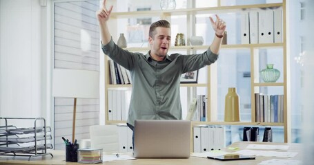 Happy young business man cheering and dancing after winning in a modern office. Confident businessman using a laptop and cheerfully celebrating success, promotion or a sale - Powered by Adobe