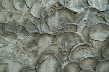 Plaster face in waves on the raw cement concrete.texture background to decorated on the wall.