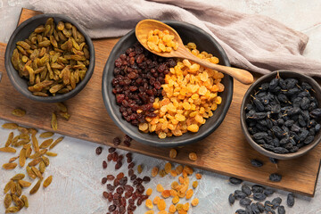 Different types of raisins on light backgroound.