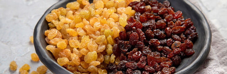 Golden and brown raisins on light  background. Dried Fruits. Top view, flat lay, copy space