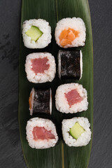 set of delicious rolls on a dark table background