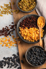 Different types of raisins on light backgroound.