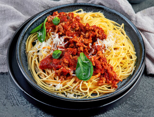 Spaghetti Bolognese on gray background.