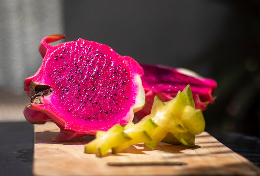Dragon fruit, Pitaya or Pitahaya on a wooden board with star fruit 