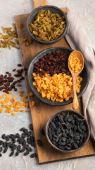 Different types of raisins on light backgroound.