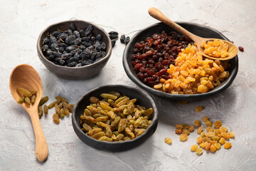 Different types of raisins on light backgroound.