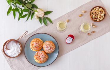 Celebrate romantic Valentine day with your love, a gift such as golden ring and a flower, tasty dessert and toasting with pistachio eggnog. Flat lay, top down view.