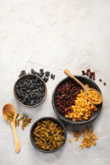 Different types of raisins on light backgroound.