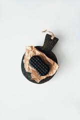 Coffee soap in craft paper lies on a white table
