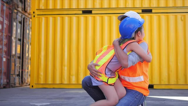 Happy family concept of father and son, Asian little girl and her father work in logistics container cargo, running to dad to give him a hug.