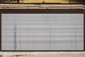close-up of melantic gray roller shutters covering a shop window