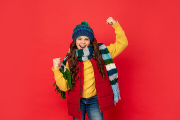 glad successful kid with curly hair in hat. female fashion model. teen girl in scarf.