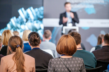 Audience watching presentation during business seminar