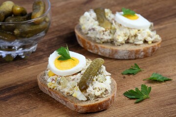 Fish pate  over brown bread with egg and pickles. Homemade spread made of sardines, eggs, cottage cheese and cut pickles.