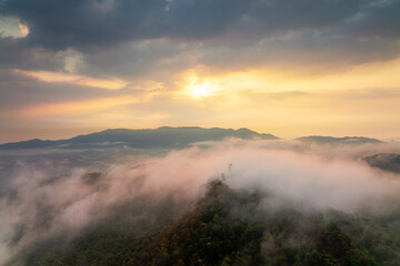 Beautiful fog in the morning forest with green mountains. Pang Puai, Mae Moh, Lampang, Thailand.
