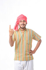 Naklejka premium Young Indian farmer showing finger after voting. voting sign in india