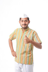 Young indian farmer showing thumps up on white background.