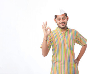 Young indian farmer in traditional wear and giving expression on white background.