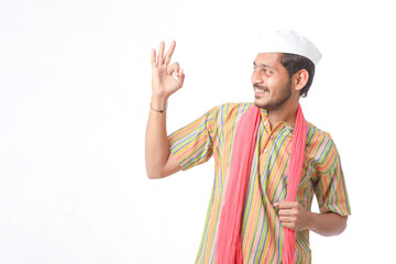 Young indian farmer in traditional wear and giving expression on white background.