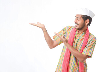Young indian farmer in traditional wear and giving expression on white background.