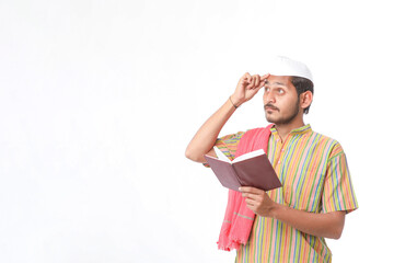 Indian farmer using diary on white background.