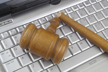 Judge gavel on laptop computer keyboard. Not working cyber laws and injustice concept.