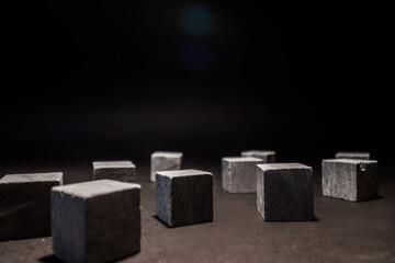 Whiskey cubes lie on a dark background. Stones for cooling drinks. High quality photo