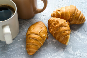 coffee mugs and croissants on the table