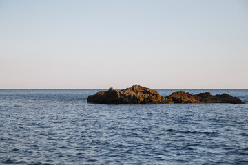 Fototapeta na wymiar Rocky island in the sea.