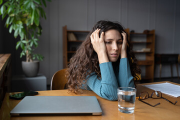 Frustrated businesswoman exhausted sit with closed laptop tired of trying to find solution to...