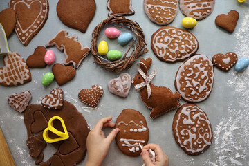 Girl decorates homemade gingerbread for Easter