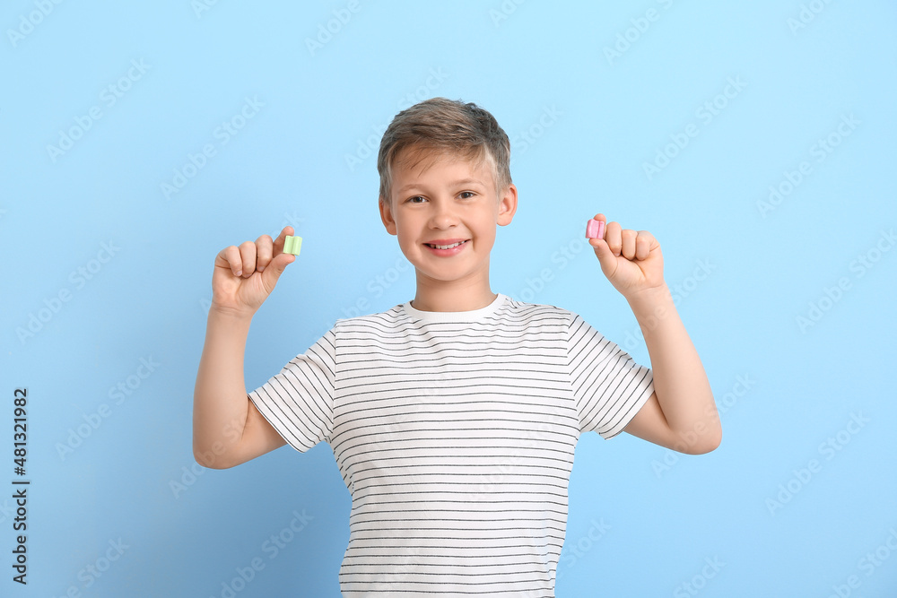 Canvas Prints little boy with chewing gums on blue background