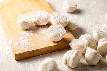 Fototapeta na wymiar Dumplings Russian raw white table, wooden board.