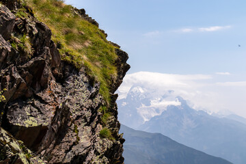 A ledge with an amazing panoramic view on the mountain ridges near Mestia in the Greater Caucasus Mountain Range, Samegrelo-Upper Svaneti, Country of Georgia. Freedom. Wanderlust