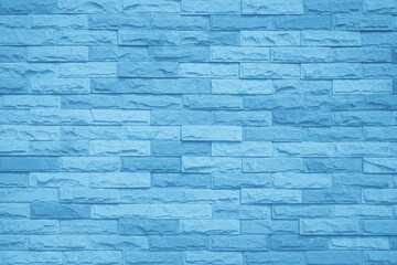 Obraz premium Brick wall painted with blue dark paint pastel calm tone texture background. Brickwork and stonework flooring interior backdrop.