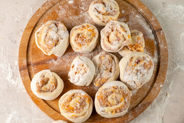 Dough with meat in the shape of a snail. Raw, top view.