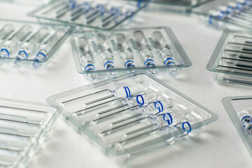 plastic transparent containers with glass ampoules on a white background