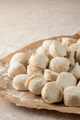 Fototapeta na wymiar Russian homemade dumplings vertical photo. Raw ravioli.