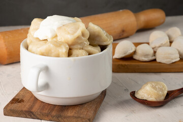 Russian traditional dumplings with sour cream.