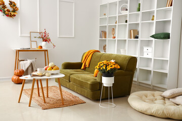 Interior of modern living room with comfortable sofa and Chrysanthemum flowers