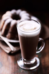 Coffee with milk on wooden background. Soft focus. Close up.
