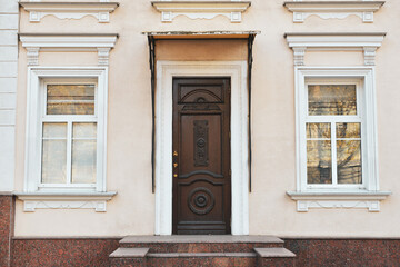 Fototapeta na wymiar Closed door of beautiful old building on city street