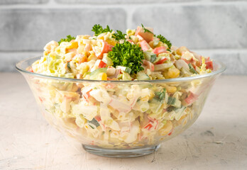 Crab salad in a large transparent bowl. Salad of crab sticks.