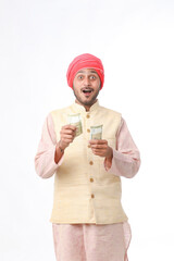 Young indian farmer counting and showing money on white background.