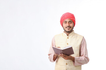 Indian farmer using diary on white background.