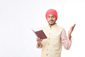 Indian farmer using diary on white background.