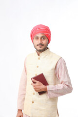 Indian farmer using diary on white background.